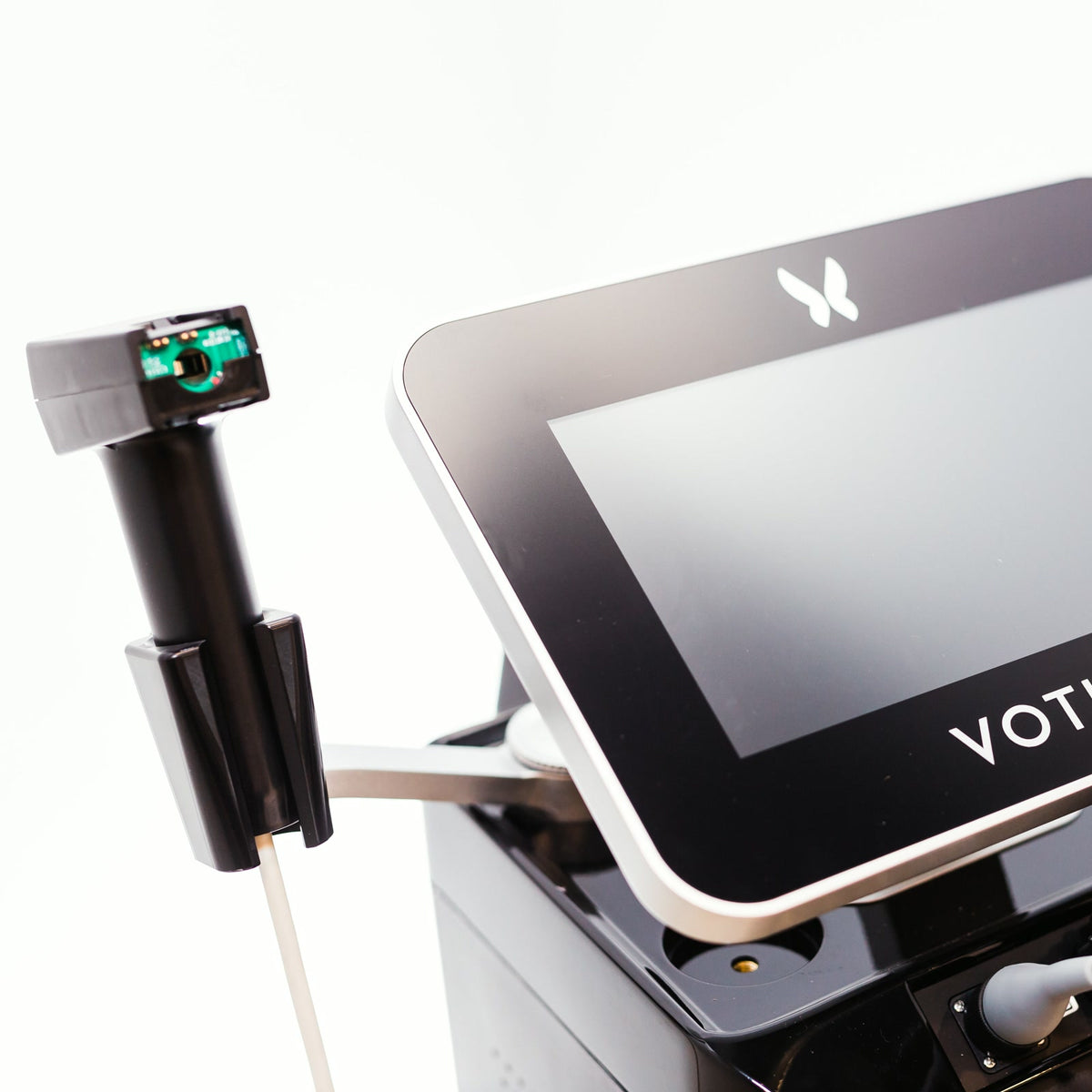 Morpheus8V radiofrequency microneedling applicator on its stand beside the treatment console